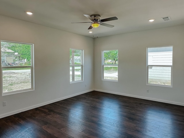 empty room with ceiling fan and dark hardwood / wood-style flooring