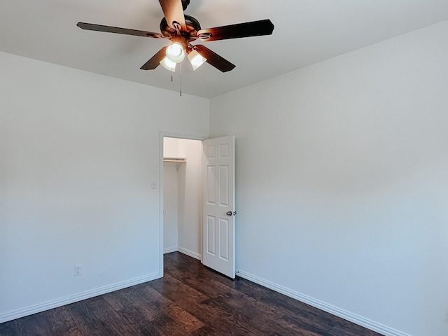 spare room with dark hardwood / wood-style floors and ceiling fan