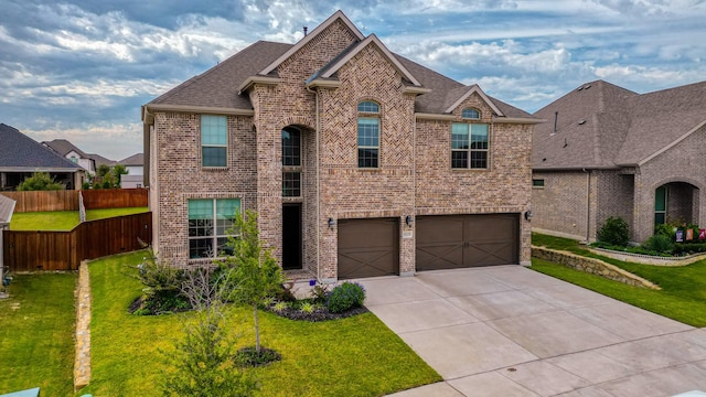 view of front of property featuring a front yard and a garage