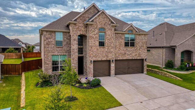 view of front of property featuring a garage and a front yard