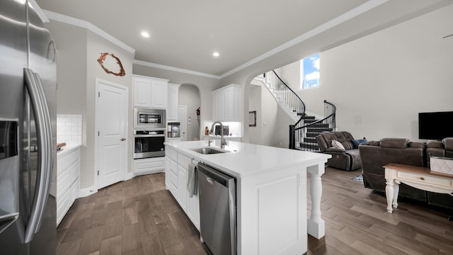 kitchen featuring appliances with stainless steel finishes, dark hardwood / wood-style flooring, sink, white cabinetry, and an island with sink