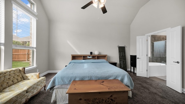 carpeted bedroom featuring ceiling fan, lofted ceiling, ensuite bathroom, and multiple windows