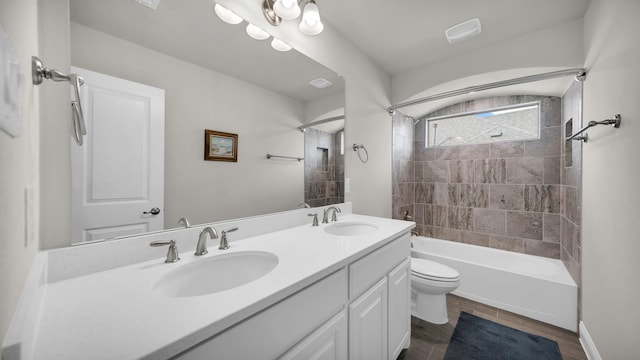 full bathroom featuring toilet, hardwood / wood-style floors, vanity, and tiled shower / bath