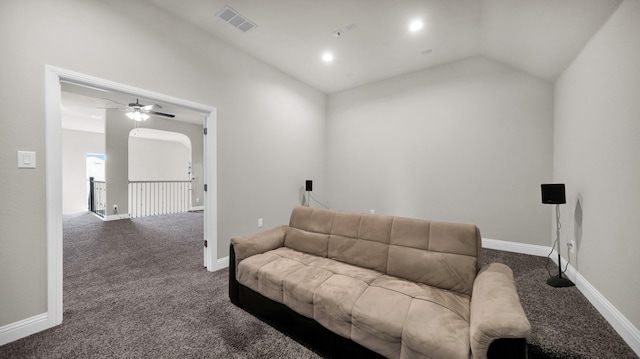 living room with ceiling fan, lofted ceiling, and dark colored carpet