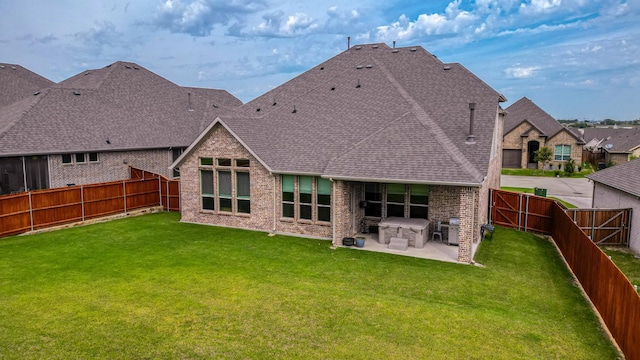 back of house with a yard and a patio