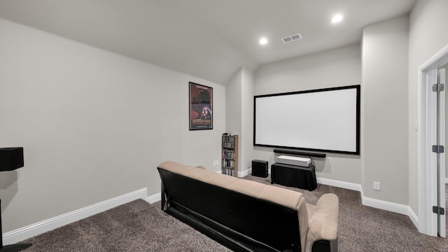 carpeted cinema room featuring lofted ceiling