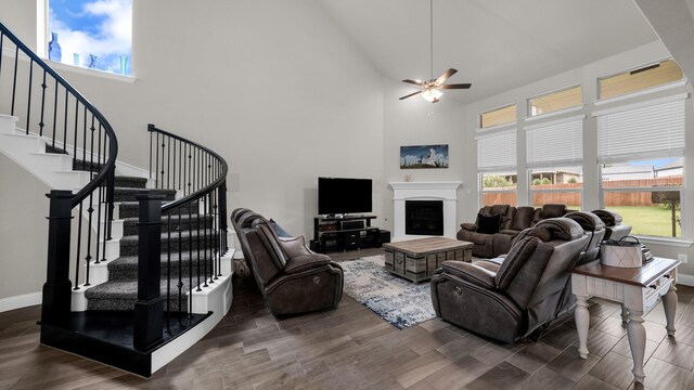 living room with a high ceiling and ceiling fan