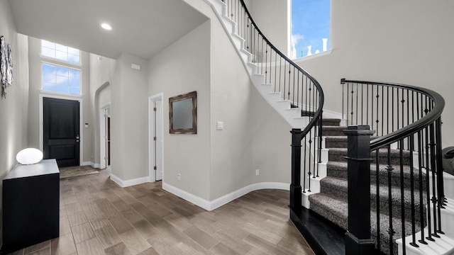 stairway with a high ceiling and a healthy amount of sunlight