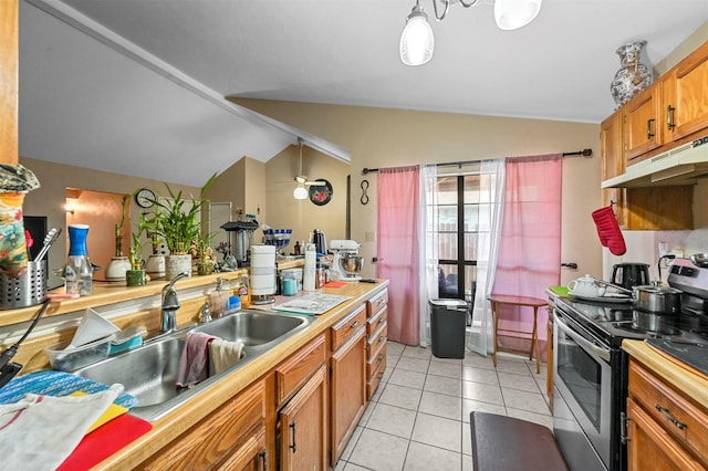 kitchen with stainless steel range with electric stovetop, sink, pendant lighting, lofted ceiling, and light tile patterned flooring