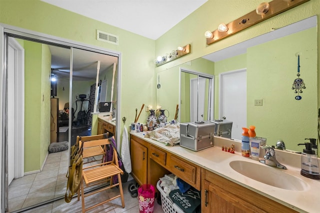 bathroom with tile patterned flooring and vanity