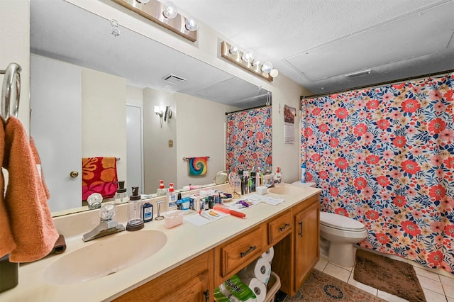 bathroom with vanity, tile patterned flooring, toilet, a textured ceiling, and curtained shower