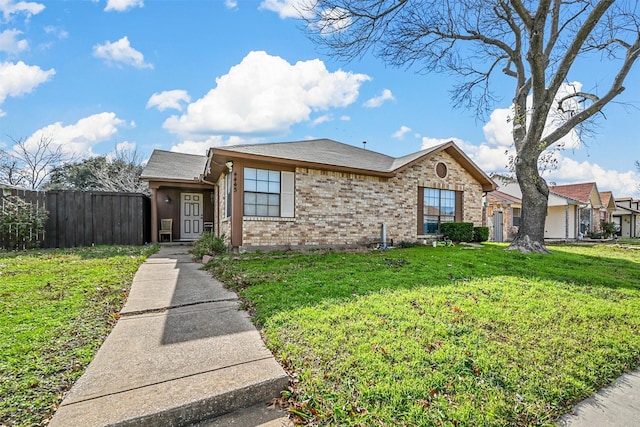 single story home featuring a front lawn