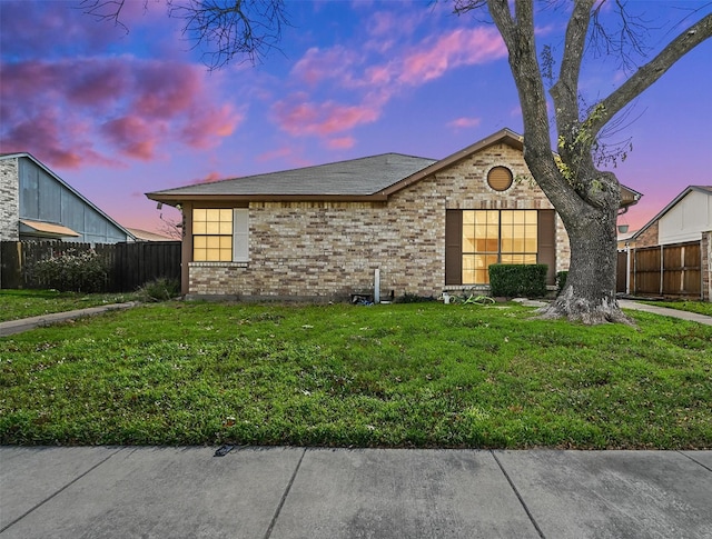 ranch-style house featuring a lawn