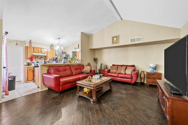 living room featuring a chandelier, light wood-type flooring, and lofted ceiling with beams