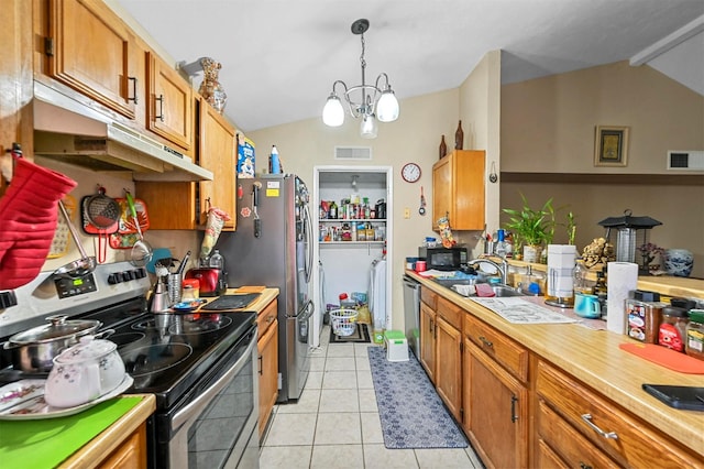 kitchen featuring an inviting chandelier, sink, hanging light fixtures, light tile patterned floors, and stainless steel appliances