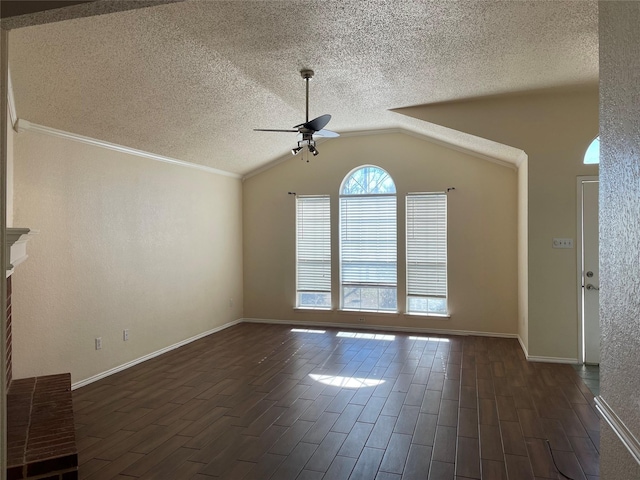 empty room with a textured ceiling, ceiling fan, vaulted ceiling, and ornamental molding