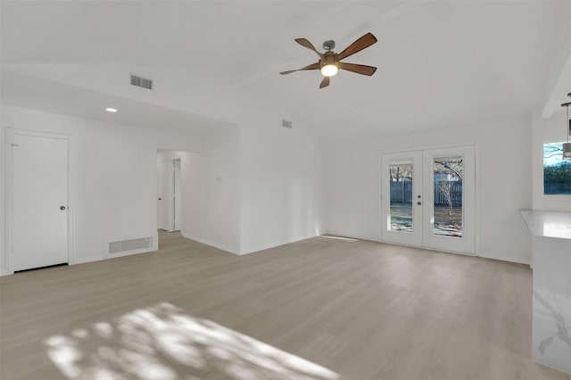 unfurnished living room featuring ceiling fan, lofted ceiling, light wood-type flooring, and french doors