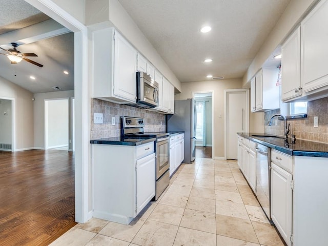 kitchen with white cabinets, sink, ceiling fan, appliances with stainless steel finishes, and plenty of natural light