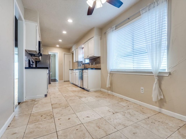 kitchen featuring decorative backsplash, stainless steel dishwasher, ceiling fan, white cabinetry, and light tile patterned flooring