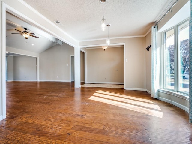 unfurnished room featuring vaulted ceiling with beams, ceiling fan, a textured ceiling, and hardwood / wood-style flooring