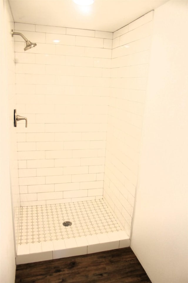 bathroom featuring tiled shower and hardwood / wood-style floors