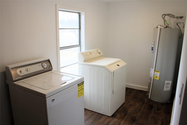 laundry area with washer and dryer, electric water heater, and dark wood-type flooring