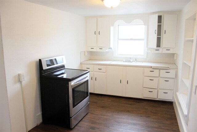 kitchen with white cabinets, sink, stainless steel range with electric cooktop, and dark wood-type flooring