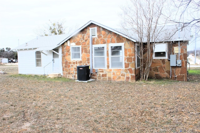 back of house with central AC