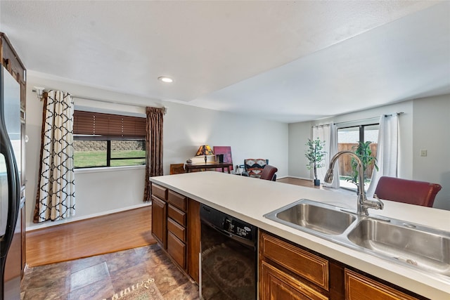 kitchen with stainless steel refrigerator, sink, and black dishwasher