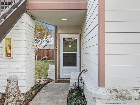 doorway to property featuring fence