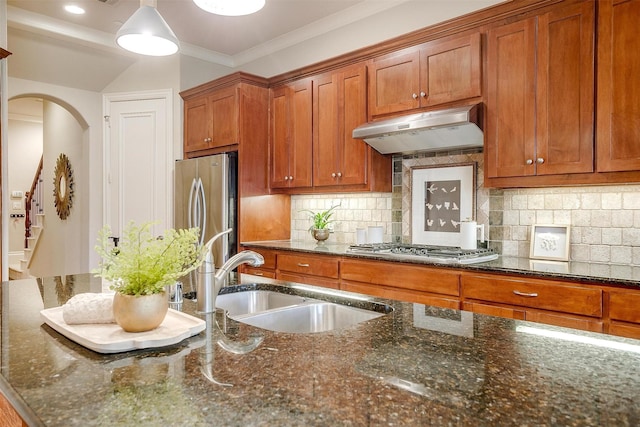 kitchen featuring dark stone counters, sink, appliances with stainless steel finishes, tasteful backsplash, and extractor fan