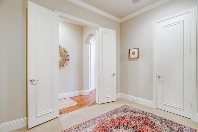 foyer with light carpet and ornamental molding