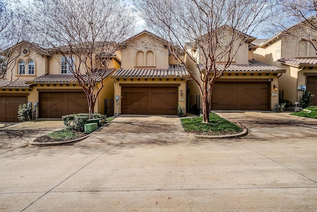 mediterranean / spanish-style home with a garage