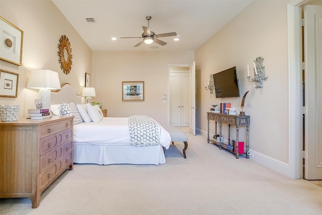 bedroom with ceiling fan and light carpet