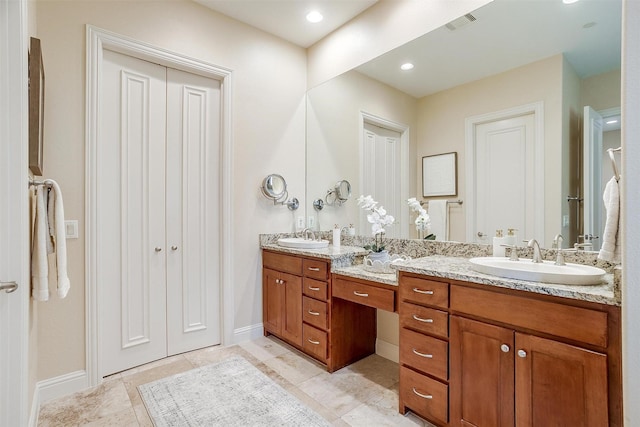 bathroom with tile patterned flooring and vanity