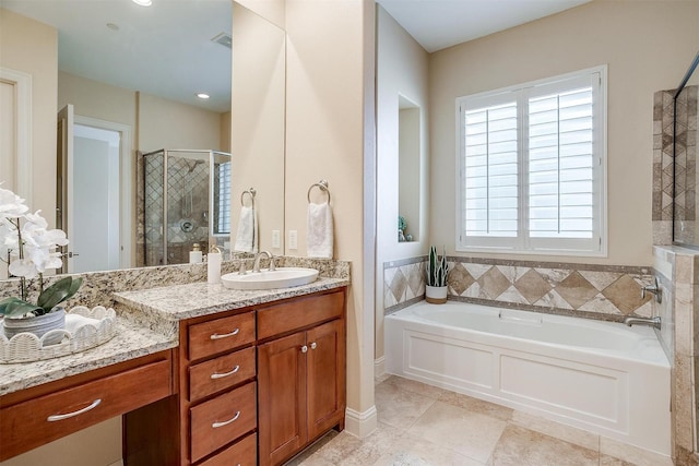 bathroom with plus walk in shower, vanity, and tile patterned floors