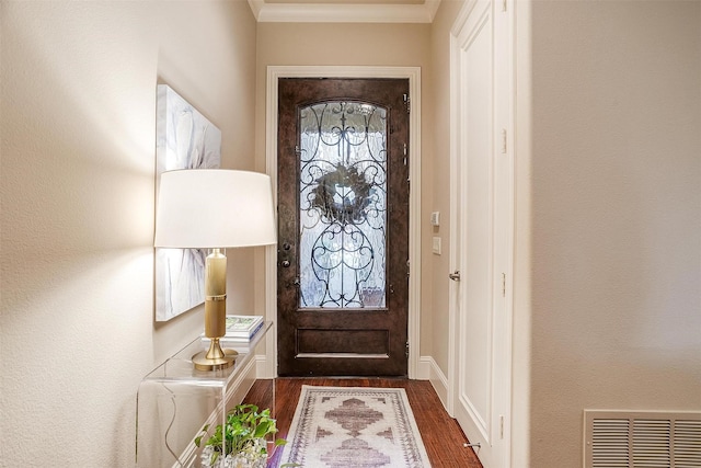 doorway to outside with crown molding and dark hardwood / wood-style flooring