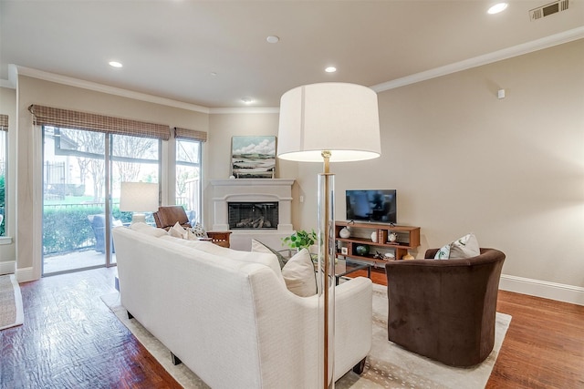 living room with wood-type flooring and ornamental molding