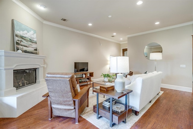 living room with crown molding and hardwood / wood-style floors