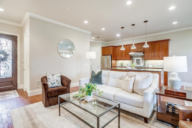 living room featuring ornamental molding and light hardwood / wood-style flooring