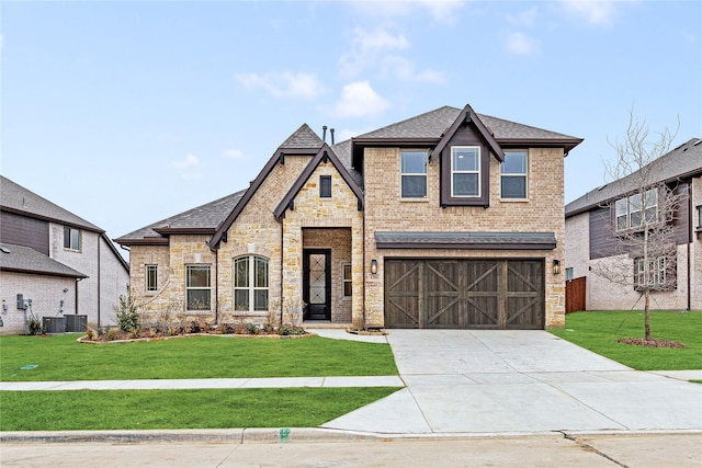 french country inspired facade with brick siding, a shingled roof, an attached garage, stone siding, and driveway