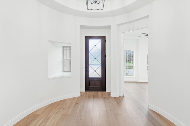 interior space featuring a notable chandelier, baseboards, and dark wood-type flooring