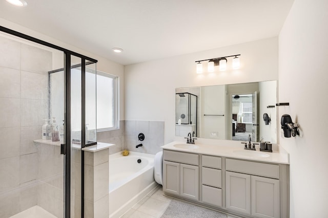 bathroom with tile patterned floors, separate shower and tub, and vanity