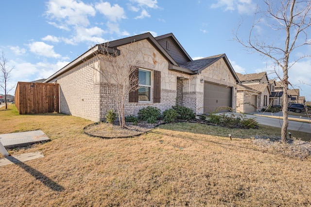 view of front of property with a garage and a front lawn