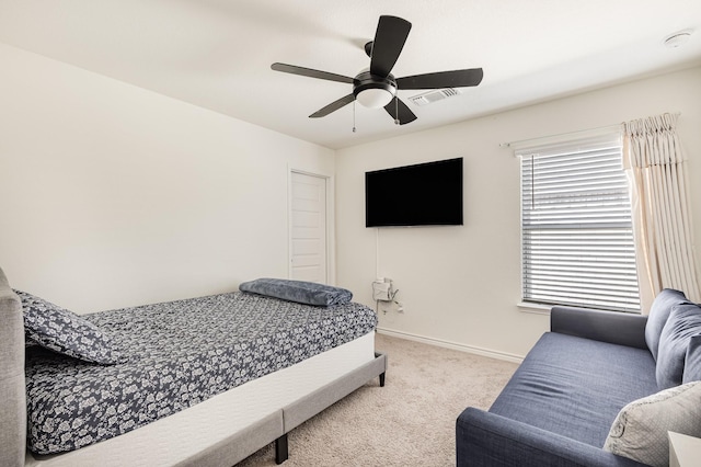 bedroom featuring ceiling fan and light carpet