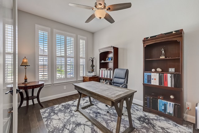 office with dark hardwood / wood-style floors and ceiling fan