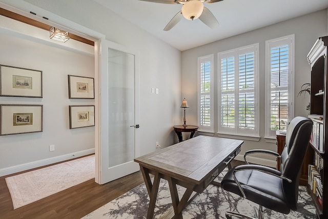 office space with ceiling fan, dark hardwood / wood-style flooring, a healthy amount of sunlight, and french doors