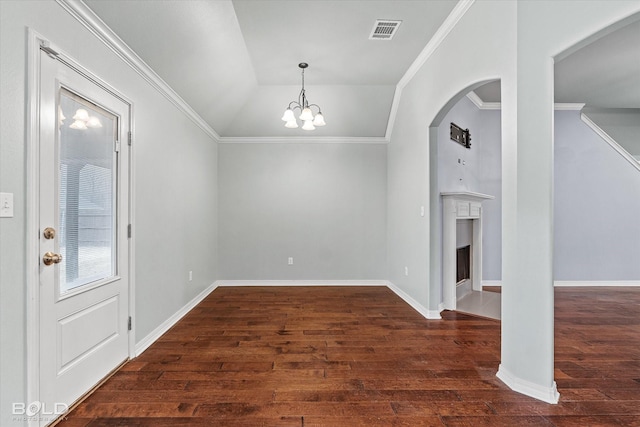 interior space with crown molding, lofted ceiling, dark wood-type flooring, and an inviting chandelier