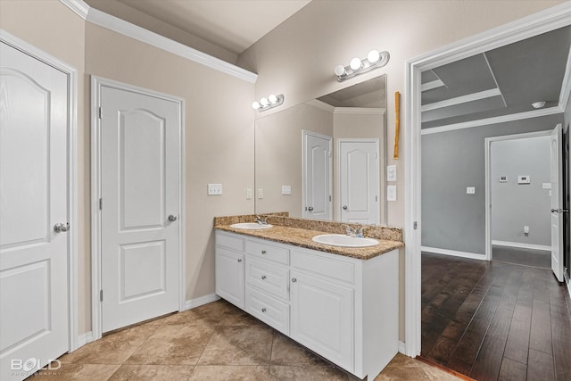 bathroom featuring crown molding and vanity