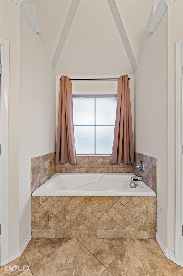 bathroom with tile patterned floors and tiled bath